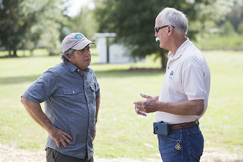 Photo of an extension agent talking to a farmer