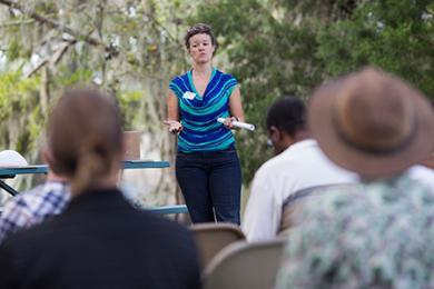 picture of faculty member presenting to members of the public at an outdoor event