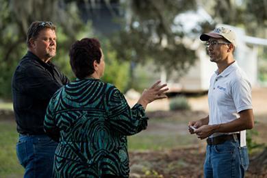 picture of a man and woman asking a question to an extension agent